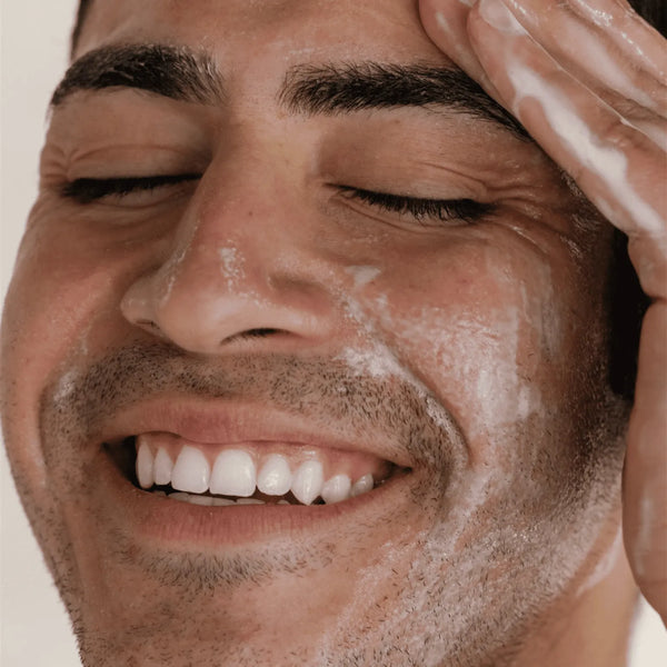Close-up of a man gently washing his face with Barrier Protect Gel Cleanser | DermaplanePro, showcasing a smooth, refreshed skincare routine.