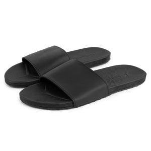 Pair of black spa and shower slides with textured footbed and wide strap, designed for comfort and durability, labeled Spa/Shower Slide | Feelgoodz.