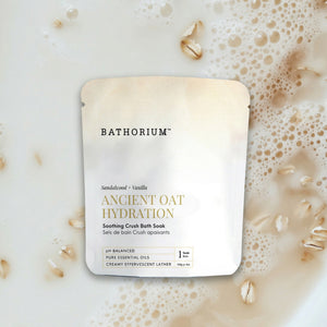 Ancient Oat Hydration Crush 120g/4oz| Bathorium soothing crush bath soak with sandalwood and vanilla shown in a creamy oat-filled bath skincare setting
