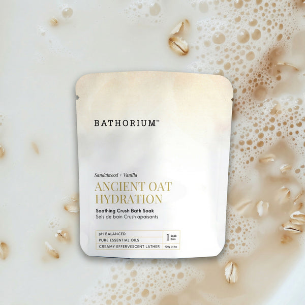 Ancient Oat Hydration Crush 120g/4oz| Bathorium soothing crush bath soak with sandalwood and vanilla shown in a creamy oat-filled bath skincare setting