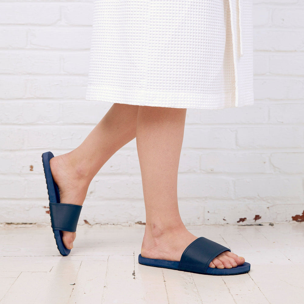 Pair of navy blue Spa/Shower Slide | Feelgoodz with textured footbed and wide strap, designed for comfortable wear during spa or shower routines.
