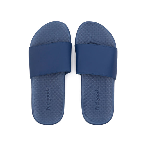 Pair of navy blue Spa/Shower Slide | Feelgoodz sandals with a textured footbed designed for comfortable wear during skincare and body care routines.