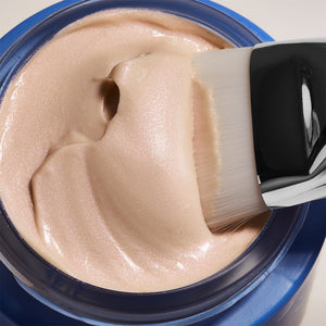 Close-up of creamy, shimmering texture of Moon Silk Moisture Recharging Mask | COOLA being gently applied with a soft brush, highlighting its luxurious skincare formula.