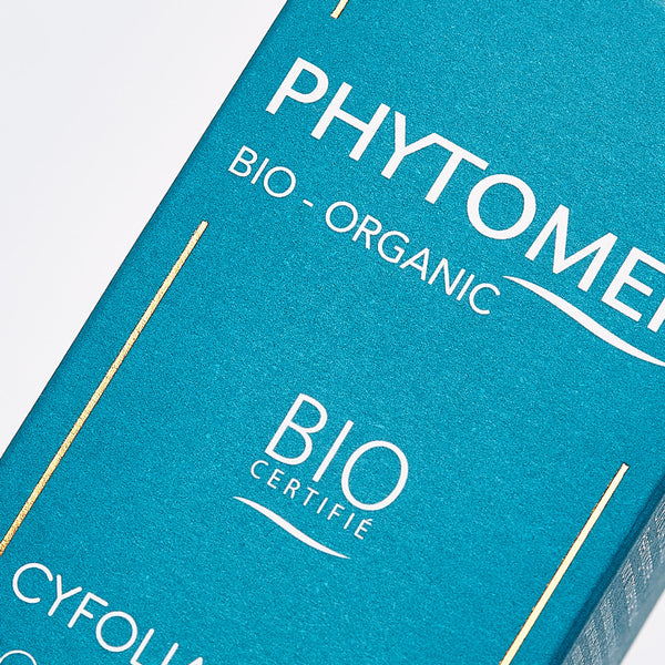 Close-up of a turquoise packaging box for Cyfolia Organic - Radiance Exfoliating Cream | Phytomer, showcasing bio-organic and certified organic skincare branding.