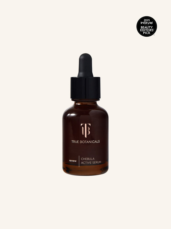 Bottle of Chebula Active Serum | True Botanicals in a brown glass container with a black dropper cap, placed against a light background for skincare and wellness use.