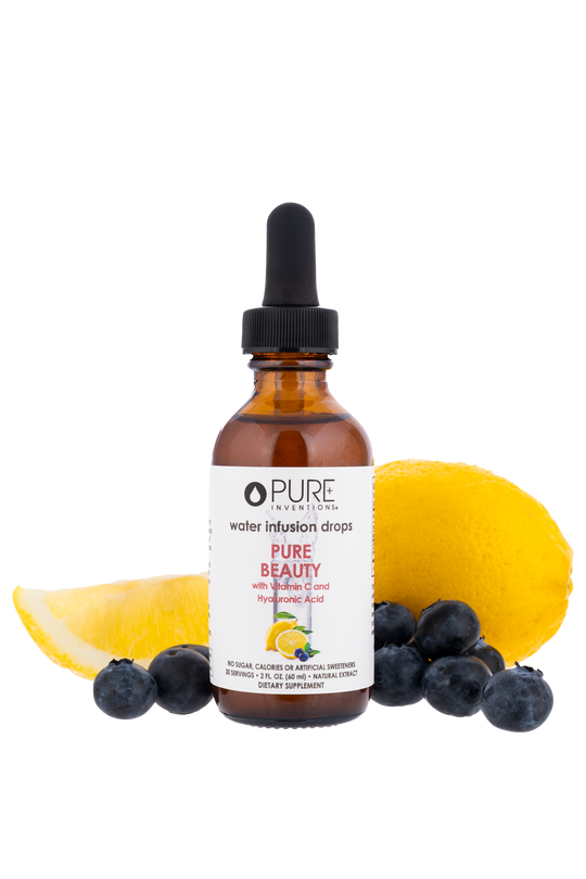Amber dropper bottle of Pure Beauty Water Infusion Drops - Berry Lemonade | Pure Inventions surrounded by fresh blueberries and lemon slices, highlighting a skincare wellness supplement.