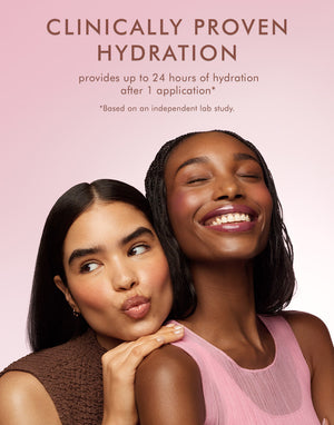 Two smiling women with radiant skin against a pink background with text about clinically proven hydration, promoting Argan Butter Lip Balm | Moroccanoil for skincare and hydration benefits.