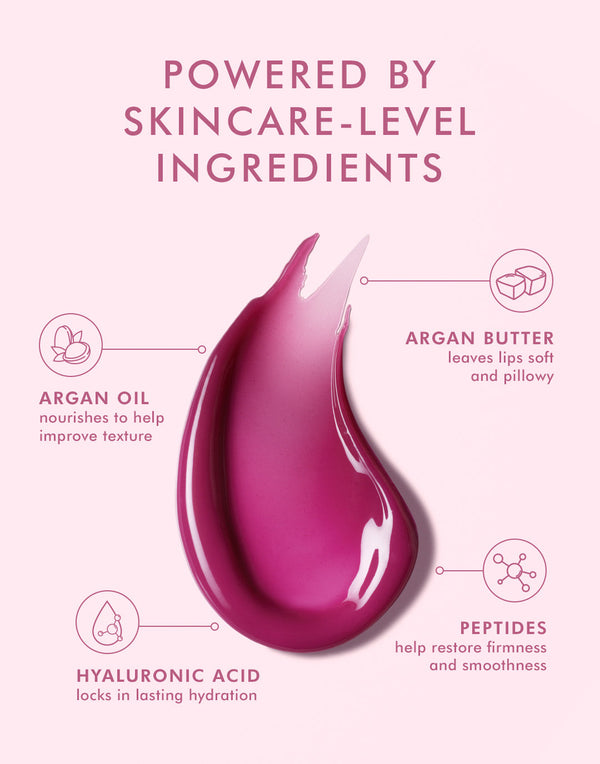 Close-up of a berry-colored lip balm swatch with text highlighting skincare-level ingredients including argan oil, argan butter, peptides, and hyaluronic acid for nourishing and hydrating benefits in Argan Butter Lip Balm | Moroccanoil.