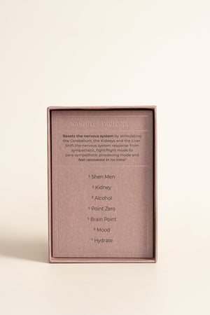 Inner packaging of Detox and Cleanse - 24K Gold Ear Seed | Vie Healing showing hangover protocol instructions for resetting the nervous system and key pressure points.