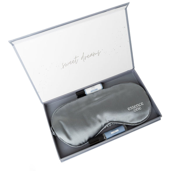 Luxury Sleep Eye Mask + Aromatherapy Set | Essence One featuring a smooth gray sleep mask and two small aromatherapy roll-ons in an elegant gift box with "sweet dreams" message inside.
