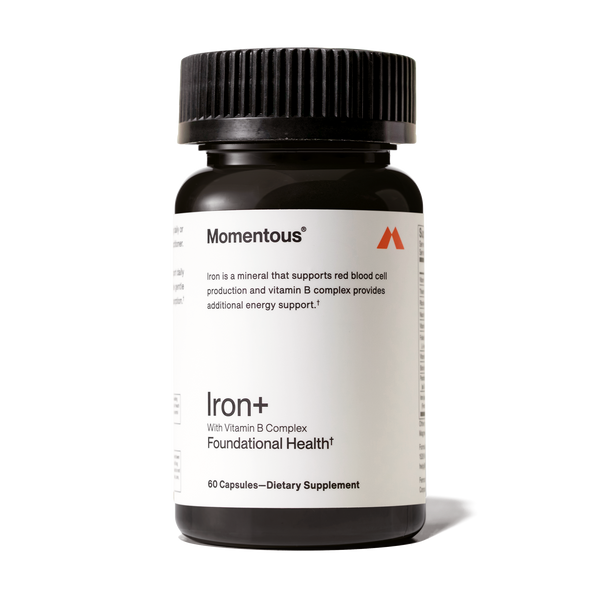 Dark amber bottle of Iron+ dietary supplement with Vitamin B Complex for foundational health and energy support, featuring a black ribbed cap.