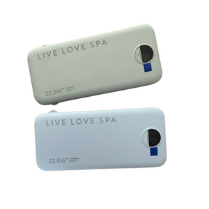 Two sleek rectangular portable chargers in soft beige and light blue colors branded with Live Love Spa, featuring 22.5W fast charging capability labeled Portable Charger Fast Charging Power Bank | Live Love Spa.