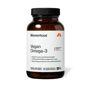 Vegan Omega-3 wellness supplement bottle with a white label and black cap shown against a dark background