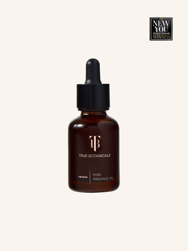 Bottle of Renew Pure Radiance Oil | True Botanicals with dropper cap in amber glass, awarded 2022 New You Beauty Awards Winner, shown against a plain light background.