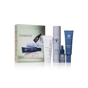 A collection of skincare products in white, blue, and lavender packaging alongside a box labeled Sensitive Essentials Kit, featuring the Sensitive Regimen Bundle | Circadia for gentle skincare.