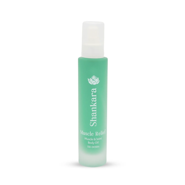 A green frosted glass bottle of Muscle Relief Oil | Shankara, designed for muscle and joint body care, featuring a white spray cap and minimalist text branding.
