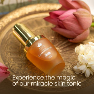 Bottle of Timeless Kumkumadi Oil | Shankara on an ornate golden tray surrounded by pink and white flowers, promoting natural skincare and wellness.