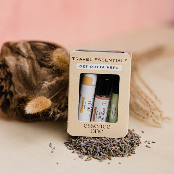 Travel Essentials - "Get Outta Here" | Essence One skincare and wellness set with three small balm tubes displayed with natural dried flowers and lavender seeds.