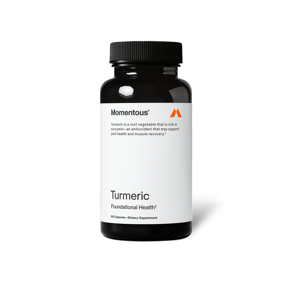 A black bottle of dietary supplement labeled Turmeric by Momentous, promoting joint health and muscle recovery with antioxidant properties.