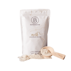 Coconut + Vanilla Milk Mineral Soak 650g | Bathorium in a white package with a wooden scoop filled with bath soak powder, promoting skincare and wellness.
