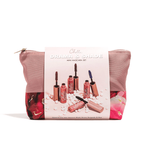 Pink and floral cosmetic bag with Chella Drama & Shade Mini Mascara Set packaging displaying five mini mascara tubes in black, brown, burgundy, and blue shades.
