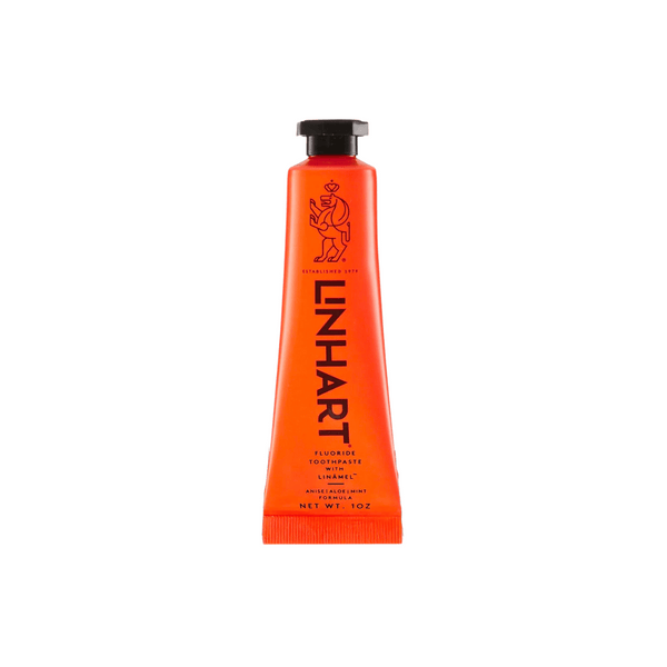 Bright orange tube of Linämel Toothpaste | LINHART featuring bold black text and a minimalist lion illustration, designed for effective oral care.