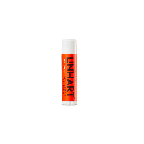 Lip Balm SPF 15 | LINHART in a white and orange tube designed for moisturizing and protecting lips with added sun protection.