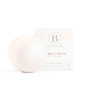 Pomelo Grove Bath Bomb | Bathorium with a smooth white spherical bath bomb and its branded packaging, designed for skincare and wellness spa experiences.