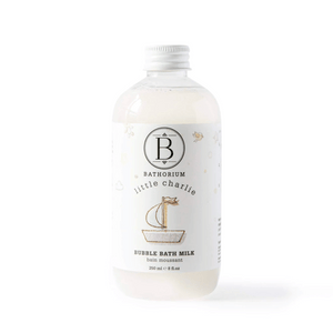 Clear bottle of little charlie™ Bubble Bath Milk | Bathorium with white cap and minimalistic label featuring a small sailboat illustration, designed for skincare and body care.