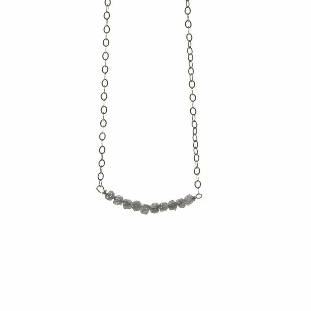 Diamonds In The Raw Sterling Silver Necklace | Liv & B featuring a delicate silver chain with a row of raw, uncut diamond stones for a natural, elegant look.