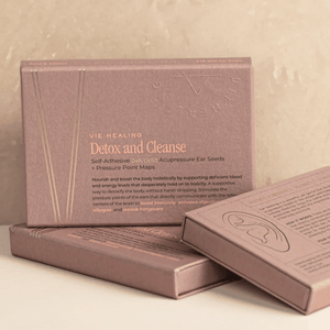 Three elegant rose gold boxes of Detox and Cleanse - 24K Gold Ear Seed | Vie Healing, featuring self-adhesive acupressure ear seeds and pressure point maps for holistic wellness and detox.