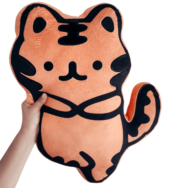 Hand holding a soft, orange plush toy with black stripe details shaped like a cute tiger, named Zen Tiger Plushie | Lucky Owl, designed for comfort and decoration.