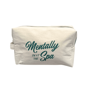 Canvas pouch with zipper and handle featuring the phrase Mentally I'm At The Spa, designed for skincare and wellness storage by Live Love Spa.