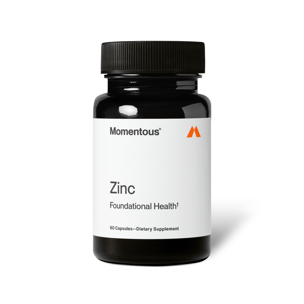 Bottle of Zinc dietary supplement by Momentous with white label and black cap, promoting foundational health and wellness.