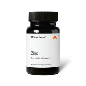 Bottle of Zinc dietary supplement by Momentous with white label and black cap, promoting foundational health and wellness.