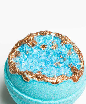 Amazonite – Geode Bath Bomb | Latika featuring a vibrant blue bath bomb designed to resemble a geode crystal with shimmering copper metallic accents, ideal for skincare and wellness.