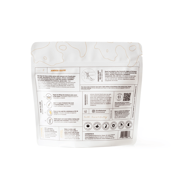 Back of the Amber Glow Clay Mineral Soak | Bathorium package showing usage instructions, ingredient details, and wellness certifications for a natural skincare mineral bath soak.