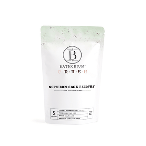 Packaging of Northern Sage Recovery Crush | Bathorium, a bath soak product designed for rejuvenating skincare and body care, featuring clean white and light green colors with essential oils and Epsom salt blend.