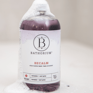 BeCalm Bubble Elixir | Bathorium bottle filled with purple liquid and foam bubbles, featuring lavender and earl grey scent for a calming bath experience.