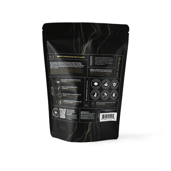 Back of packaging for Hinoki Cypress Magnesium Bath Flakes | Bathorium showing usage instructions, safety icons, and product details on a black resealable pouch.