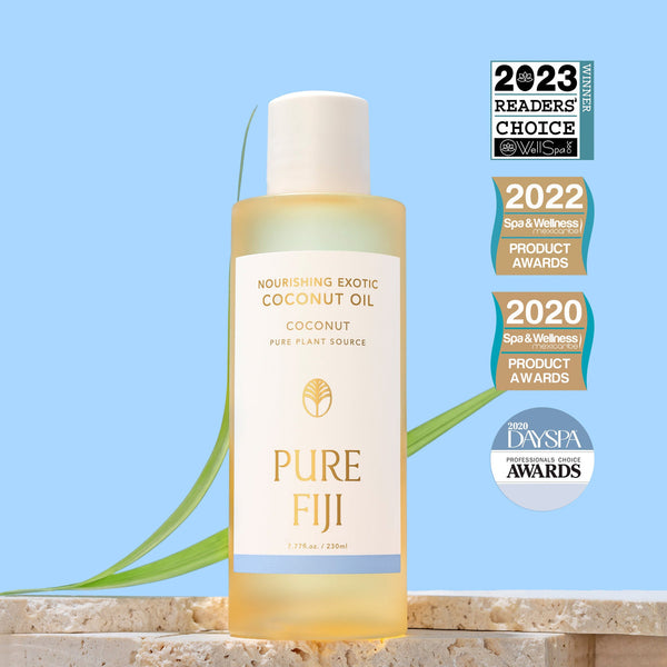 Bottle of Nourishing Exotic Coconut Oil | Pure Fiji displayed with award badges against a light blue background, highlighting its skincare and body care benefits.