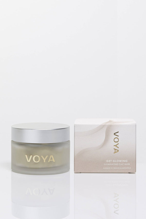 Clear glass jar with silver lid and matching minimalistic box of Get Glowing Illuminating Clay Mask | VOYA, a skincare product designed for radiant skin.