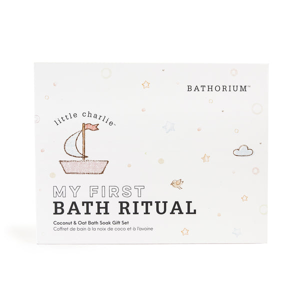Packaging of little charlie™ My First Bath Ritual Gift Box Set | Bathorium featuring a simple boat illustration and soft pastel star and cloud accents on a white background.