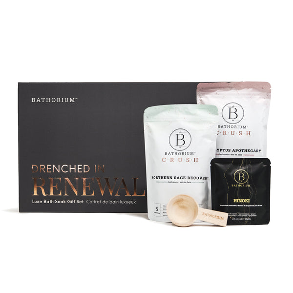 Drenched In Renewal Gift Box Set | Bathorium featuring three bath soak pouches in soft pastel and black packaging with a wooden scoop, designed for skincare and body care wellness rituals.