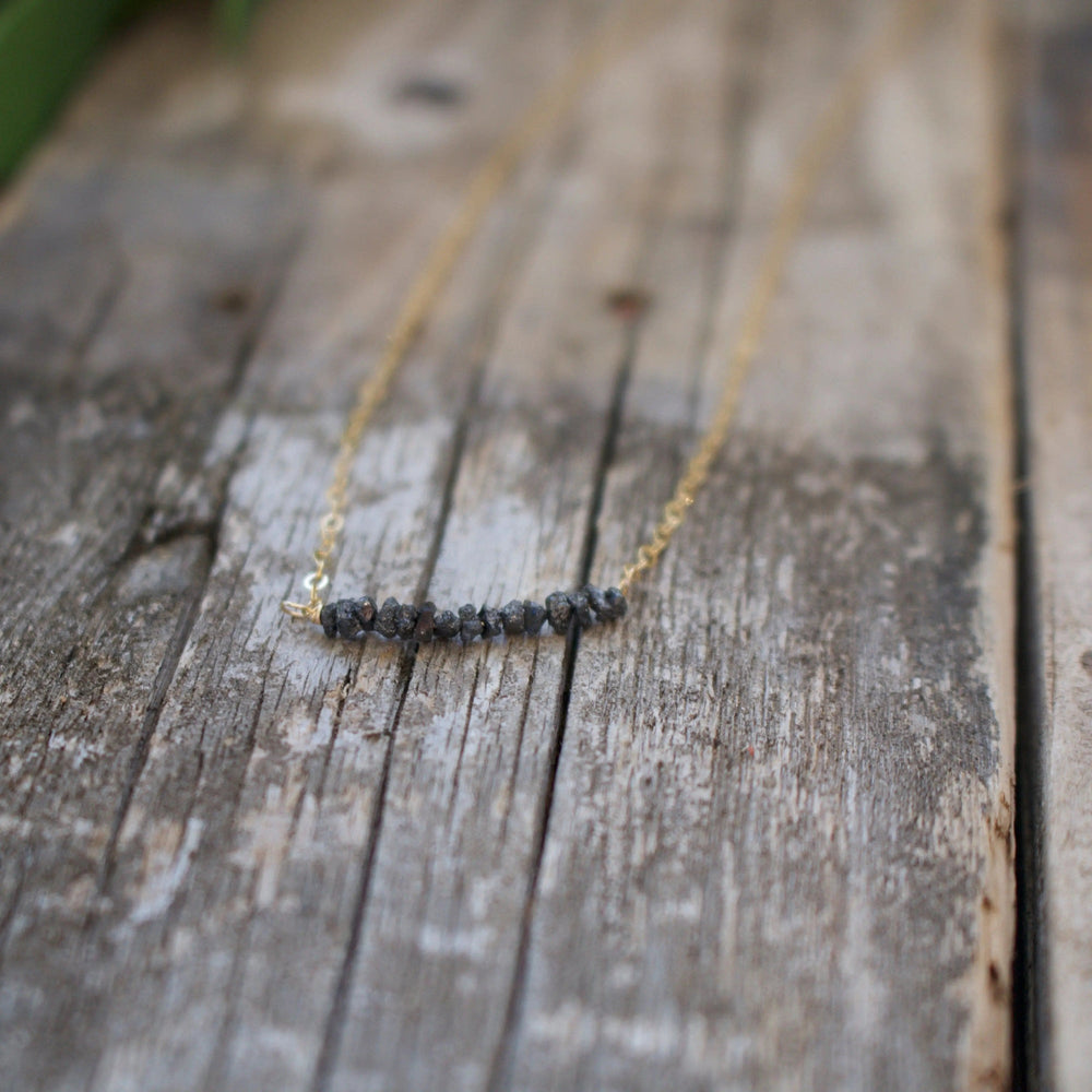Diamonds In The Raw Sterling Silver Necklace | Liv & B featuring a delicate silver chain with a row of raw, uncut diamond stones for a natural, elegant look.