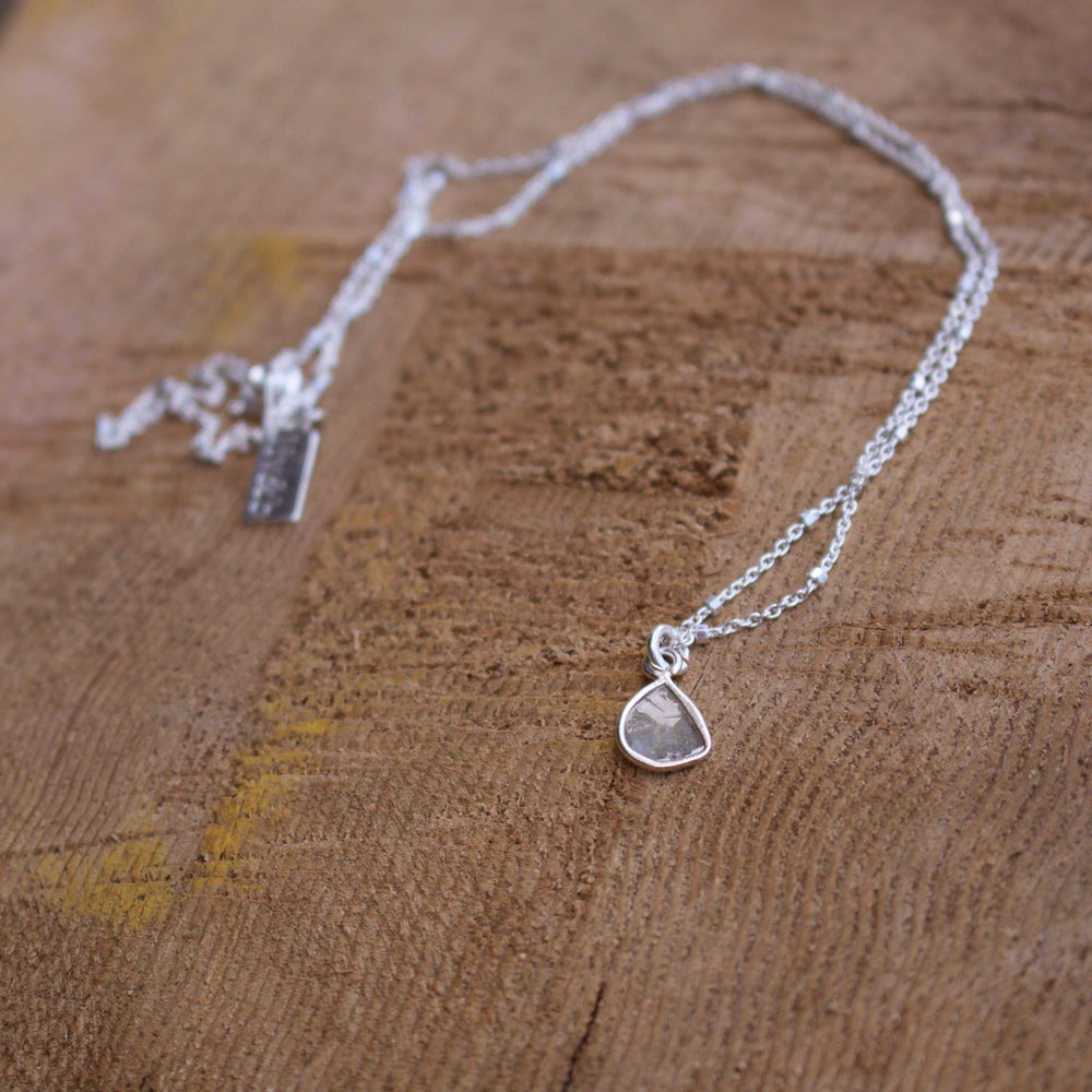 Diamond Slice Sterling Silver Necklace | Liv & B featuring a delicate sterling silver chain with a unique teardrop-shaped diamond slice pendant, perfect for elegant everyday wear.