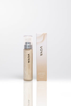 Luminosity Refining Radiance Exfoliator | VOYA in a sleek beige bottle with matching box, designed for skincare and radiance enhancement.