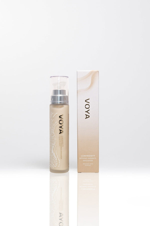 Luminosity Refining Radiance Exfoliator | VOYA in a sleek beige bottle with matching box, designed for skincare and radiance enhancement.