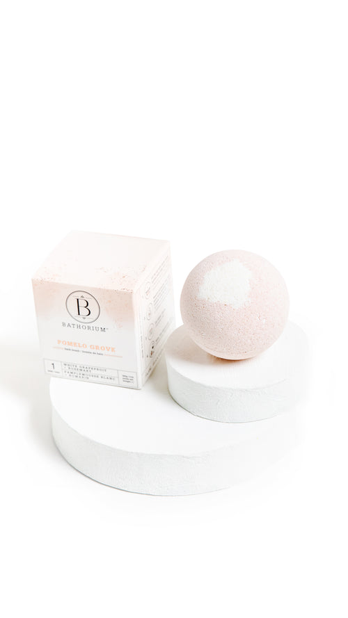 Mama's Perch Bath Bomb | Bathorium, a soothing pink bath bomb with subtle white accents, displayed next to its minimalist packaging, perfect for skincare and wellness rituals.