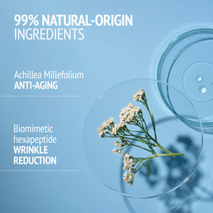 Close-up of delicate white flowers on a clear petri dish alongside another empty dish on a light blue background, highlighting 99% natural-origin ingredients in Sublime Skin Intensive Serum | [ comfort zone ] for skincare and anti-aging benefits.